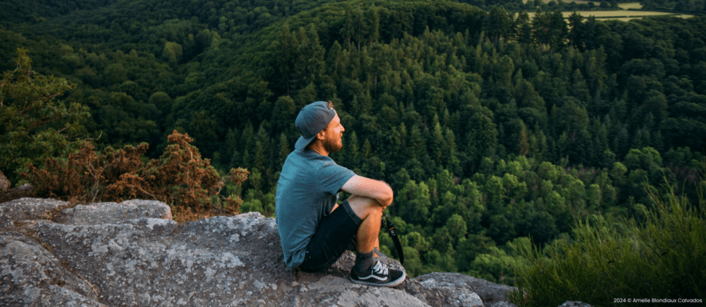 Wanderer betrachtet Calvados Panorama mit Wald